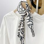 Black and white silk scarf tied