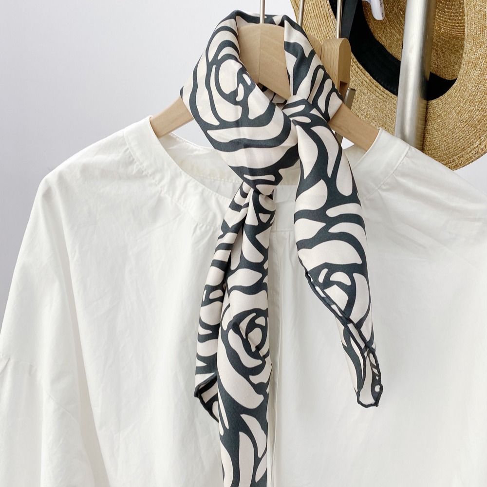 Black and white silk scarf tied