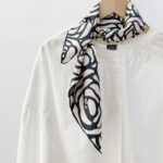 Black and white silk scarf tied