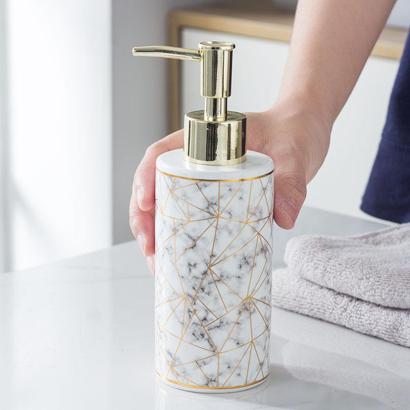 Ceramic marble soap dispenser in hand – modern minimalist bathroom accessory